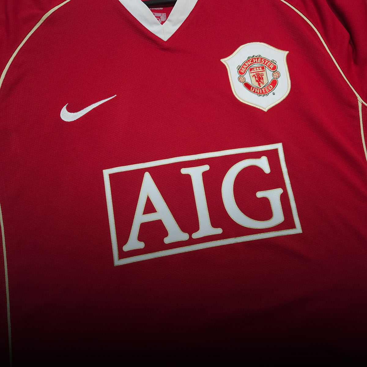 Manchester United club crest detail on red home football shirt