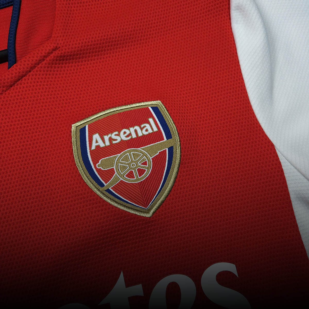 Arsenal club crest detail on red home football shirt