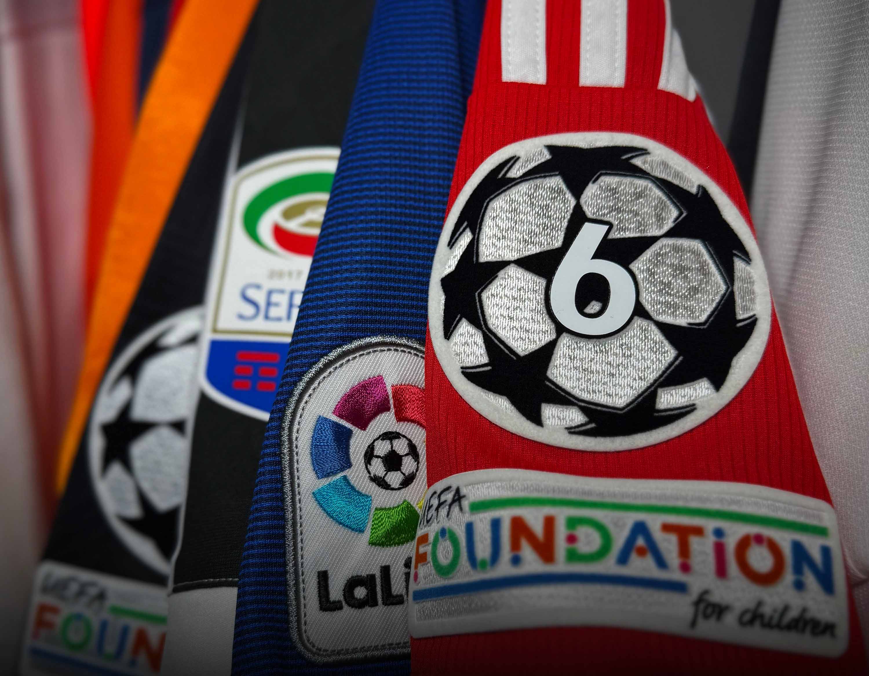 Collection of sports jerseys with various logos including UEFA, La Liga, and FIFA Foundation.